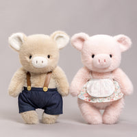 Duo di peluche a forma di maialino vestito