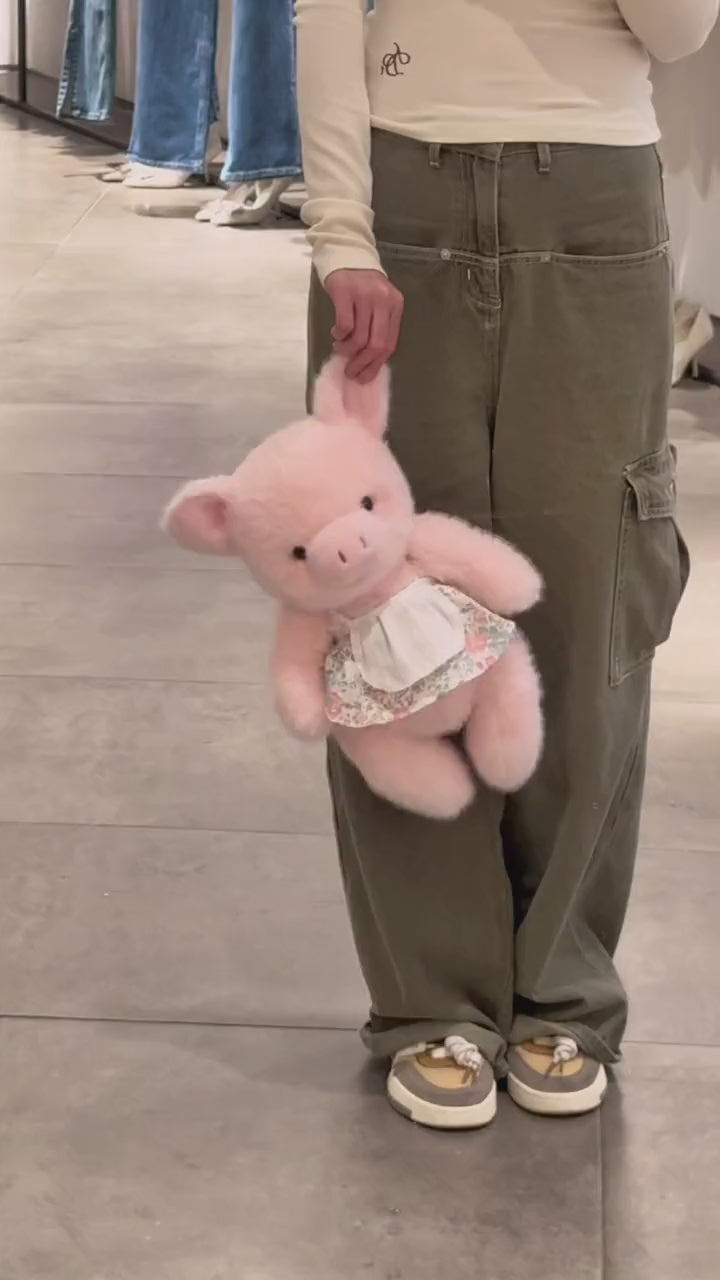 Duo di peluche a forma di maialino vestito